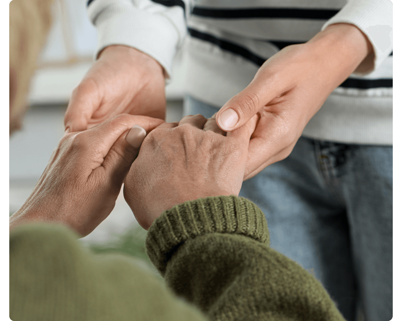 Hands joined together in a supportive gesture