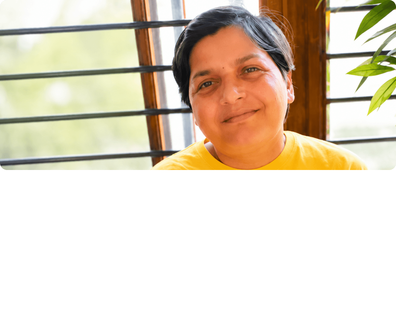 Mukta smiling in a yellow t-shirt