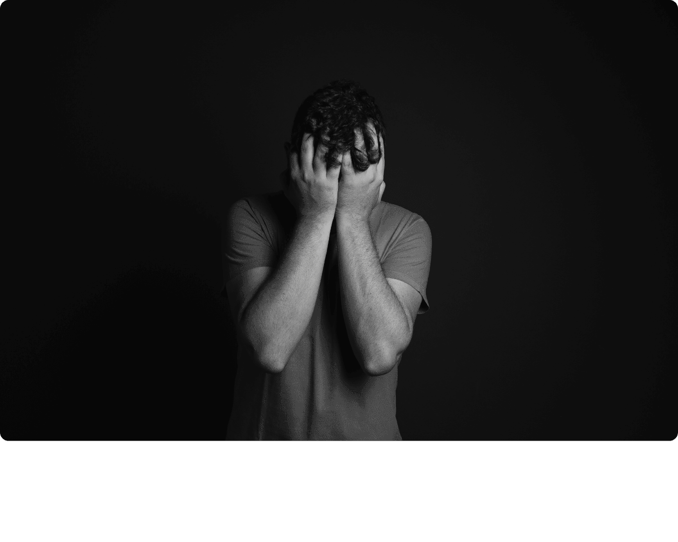 Person with their hands over their face